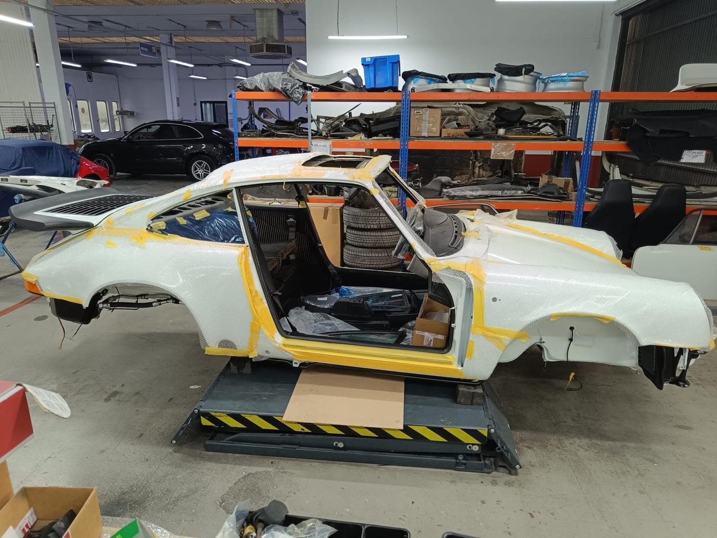 Bodyshell of a G-series 911 masked up in the bodywork and paint shop