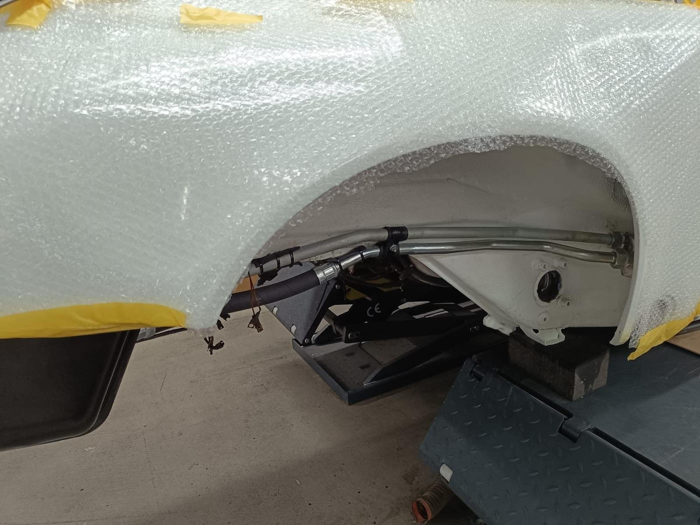 Wheel arch protected with bubble wrap during the paint process
