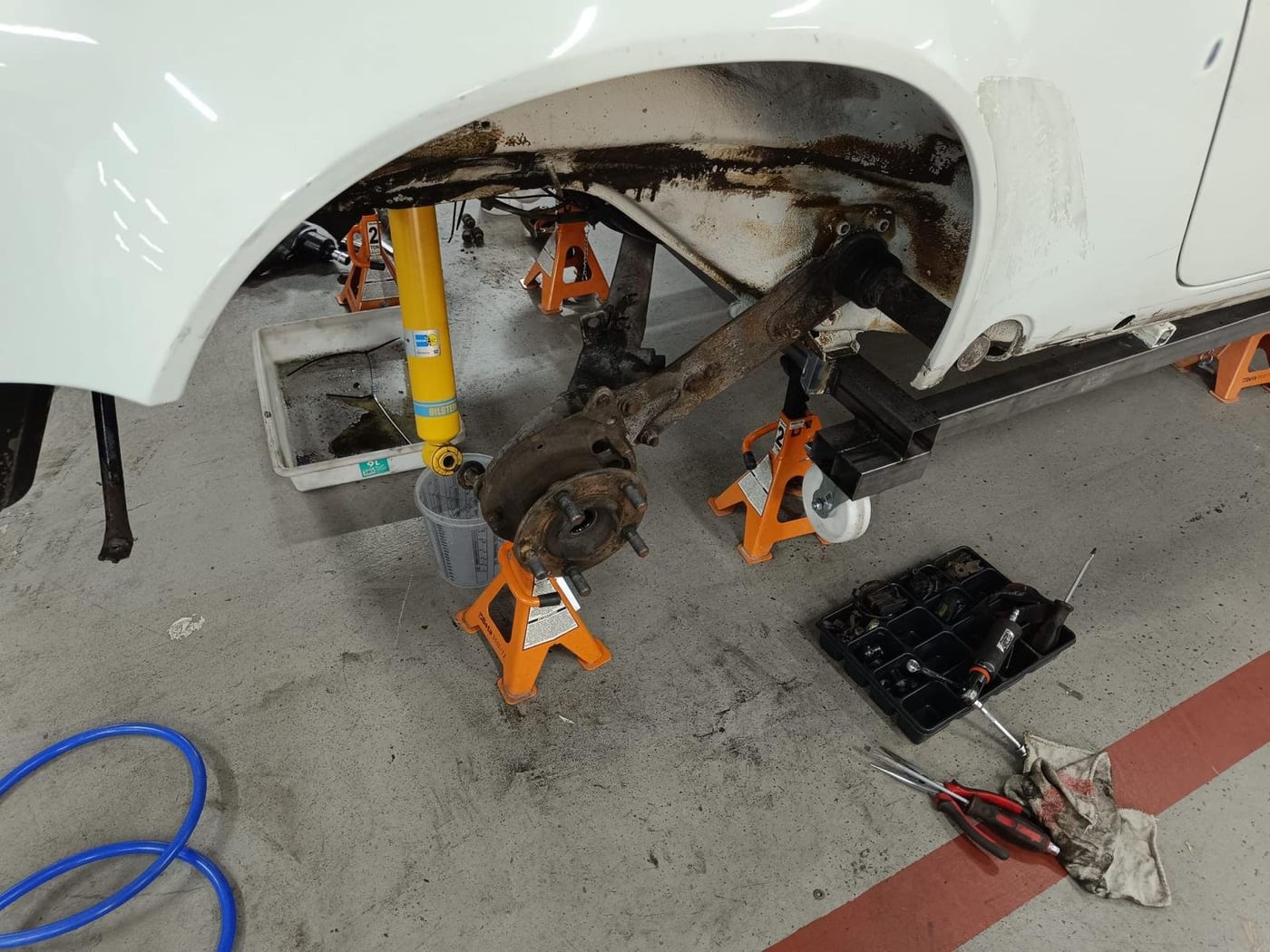 Front suspension of the G-series 911 stripped out, the car on axle stands