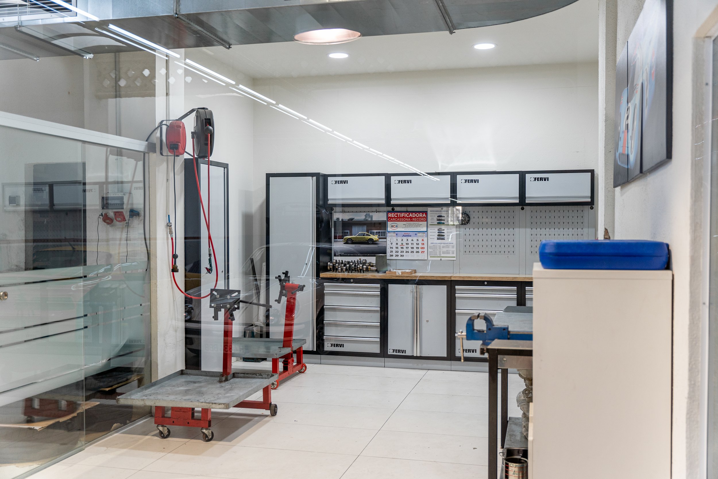Sala de motores vista a través del cristal, con los bancos de trabajo y los soportes de motor